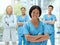 Portrait, medicine and a black woman nurse arms crossed, standing with her team in a hospital for healthcare. Leadership