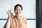 Portrait of middle age asian woman smiling face and showing ok sign at home,Health care insurance concept