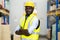 Portrait of middle aged African American warehouse worker in large warehouse distribution centre