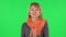 Portrait of middle aged blonde woman is waiting in anticipation with pleasure. Green screen