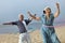Portrait of Middle Aged Chinese Couple Hula Hooping on the beach