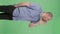 Portrait of a middle aged men calling someone. Balding male with beard in blue shirt posing on green screen in the