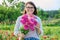 Portrait of a middle aged woman with a bouquet of flowers outdoor