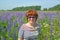 Portrait of a middle-aged woman in sunglasses among blooming lupins