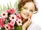 Portrait of miling beautiful young woman with bouquet flowers