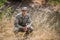 Portrait of military soldier crouching in grass