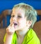 Portrait mischievous cute blond blue eyed boy making freckles face play laughing in happy mood. Funny photo, happiness