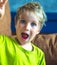 Portrait mischievous cute blond blue eyed boy making freckles face play laughing in happy mood. Funny photo, happiness