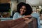 Portrait mixed race woman with afro happy and enjoying time at home