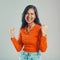 Portrait of mixed race woman  against grey studio background with copyspace. Young hispanic standing alone and