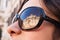 Portrait of a model with Trevi\'s fountain reflected on sunglasse