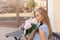 Portrait of modern fashion trendy women sitting in outdoor restaurant with Bouquet of peonies