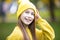 Portrait of modern happy teen girl with dental braces dressed in yellow clothes in park. Pretty teenage girl wearing