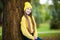 Portrait of modern happy teen girl with dental braces dressed in yellow clothes in park. Pretty teenage girl wearing