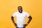 Portrait of a modern young black man smiling standing on isolated yellow background