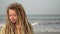 Portrait of modern young hippie woman on sea sandy beach