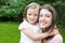 Portrait mom and daughter in happines at the outside in the meadow