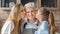 Portrait of mom and daughter kissing granny