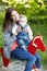 Portrait, mother and baby with toy, horse and park for fun in bond by playing for outside together. Happy woman, infant