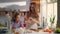 Portrait of mother and daughter cracking eggs in glass bowl on kitchen