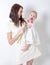 Portrait  mother and daughter ,  woman in a white dress with a baby in a white dress, flowers