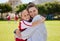 Portrait of mother and girl hug at soccer training, bonding and embracing on a field. Sport, fitness and support by
