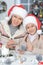 Portrait of mother and her daughter making decorations