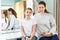 Portrait of mother and her teenager daughter sitting in dressing room, looking at camera