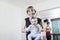 Portrait of mother holding her baby in the yoga studio, looking at camera