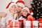 Portrait of mother with sons wearing santa hats