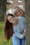 Portrait of mother and teenage daughter behind a tree