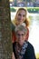 Portrait of mother and teenage daughter behind a tree