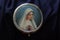 Portrait of Mother Virgin Mary on a cover of round metal rosary box. Pray rosary devotion concept. Catholic religion symbol.