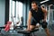 Portrait Of Motivated Black Sportsman Exercising With Dumbbell At Gym