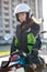 Portrait of motorbiker Caucasian woman in white open face crash helmet and touring jacket sitting on motorcycle