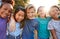 Portrait Of Multi-Cultural Children Hanging Out With Friends In Countryside Together