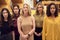 Portrait Of Multi-Cultural Female Business Team Standing In Modern Open Plan Office