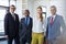 Portrait of multi-ethnic business people standing together in office