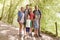 Portrait Of Multi Generation Family Enjoying Walk Along Woodland Path Together