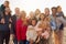 Portrait Of Multi-Generation Family Group With Dog On Winter Beach Vacation