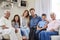 Portrait Of Multi Generation Family Sitting On Sofa At Home