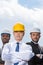 Portrait of multiathic group of professional architects in hard hats