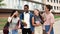 Portrait of multicultural group of happy students looking at camera with backpacks and notebooks. Diverse people smiling