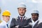 Portrait of multiethic group of professional architects in hard hats