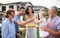 Portrait of multigeneration family outdoors on garden barbecue, grilling.