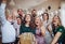 A portrait of multigeneration family with presents on a indoor birthday party.