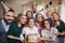 A portrait of multigeneration family with presents on a indoor birthday party.