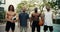 Portrait of a multiracial basketball team whose members are standing, smiling and looking at the camera on the