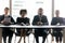 Portrait of multiracial businesspeople sit at desk in office