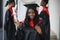 Portrait of multiracial graduates holding diploma